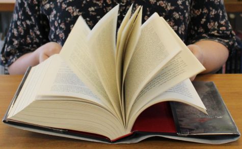 Starr’s Mill High School student quickly flips through the thrilling adventure novel “Six of Crows” by Leigh Bardugo. The sequel to to this book “Crooked Kingdom” was published on Sept. 22, 2016. 