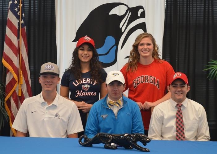 Seniors Jake Arnold, Alexis Berrios, Andrew Crockett, Will Tiller, and Donna Blaum gather in the Starr’s Mill Media Center to sign with their respective universities on Nov. 9. 