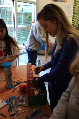 Students work to sort and pack boxes for Operation Christmas Child. Boxes like these are sent to locations around the world to give supplies and toys to children in need.