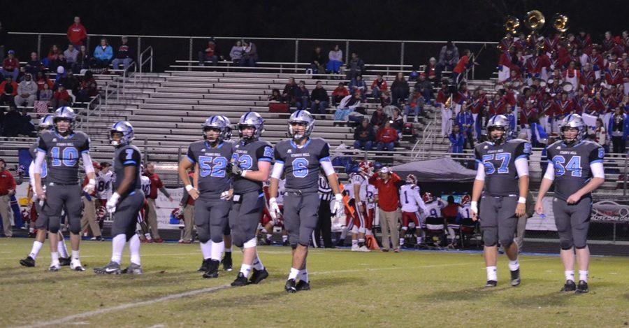 Members of the Panther defense look toward the sideline to listen for the next playcall. The defense forced two interceptions and recovered two fumbles on special teams to help the Panthers move into the second round of the AAAAA GHSA State Playoffs.