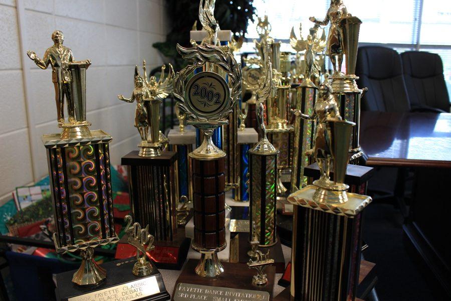 Trophies+begin+to+pile+up+as+front+office+secretary+Leslie+Frey+catalogs+them+before+handing+them+off+to+the+coaches.+The+school%E2%80%99s+most+important+trophies+will+be+placed+chronologically+around+the+rotunda.+Additional+trophies+will+be+given+to+the+coaches+at+the+Mill%2C+who+will+then+have+to+figure+out+what+to+do+with+them.+