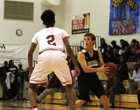 A Panther player looks for an open man to pass to during a scrimmage against Our Lady of Mercy. The Panthers dominated during their 76-46 win over the Bobcats.