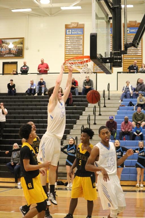 A Panther player dunks the ball during the Panthers first round contest against Harris County. The back and forth matchup resulted in a 64-58 win for the Panthers. 
