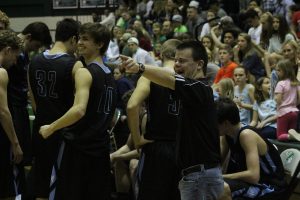 Basketball manager Ethan Harris cheers on the Panthers during their game against McIntosh on Jan. 20. Harris has been a manager for the boys’ basketball team for 10 years.