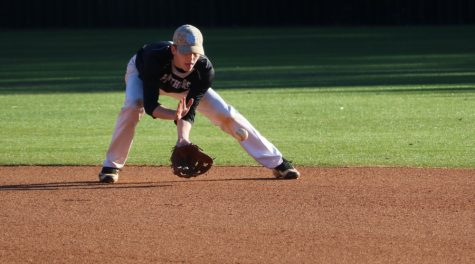 Junior Mitchell Sutton fields a ball at shortstop. The varsity boys play their first home game March 2 against Morrow.