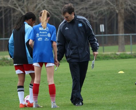 Head coach John Bowen instructs two soccer players at practice. The Lady Panthers start their season with a revamped offense at home against Sandy Creek tomorrow at 5:55 p.m.