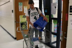 Every Friday, students from business teacher Jeffrey Klein’s entrepreneurial class dump the blue recycling bins in each classroom into a shopping cart. The cart is eventually taken to the recycling dumpsters outside of the cafeteria.