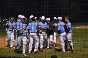 The Panther varsity baseball team gathers at home plate after senior Will Evans hit a two-run home run in the bottom of the first. The Panthers defeated the Wildcats in a 15-run mercy rule in the bottom of the third, improving their overall record to 8-1.