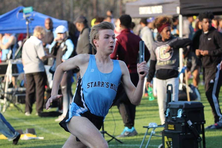 A Starr’s Mill runner prepares to exchange the baton with a teammate in a relay race. “Our 4X4 team is solid, but we need to improve in our hurdling,” Walker said. 