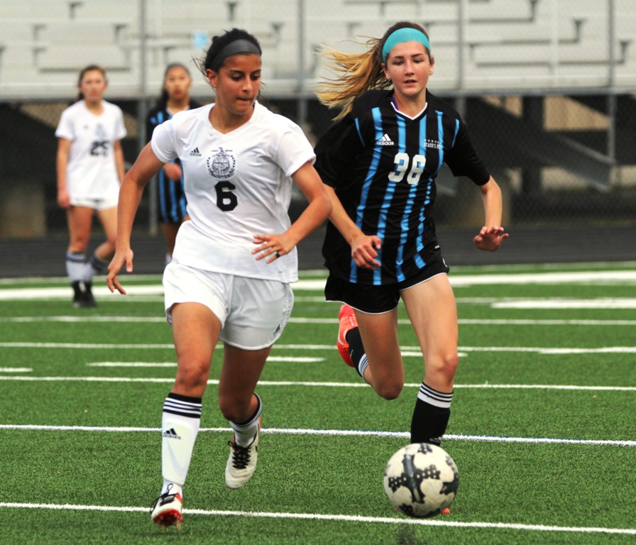 A Lady Panther chases a Lady Chief down the field as she attempts to advance with the ball. The Lady Panthers lost the Battle of the Bubble 3-0 to McIntosh. 