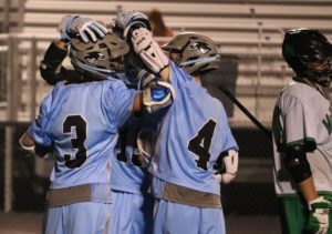 Panther players huddle after scoring a goal against McIntosh. Seven different players scored in the Panthers 15-10 victory. 