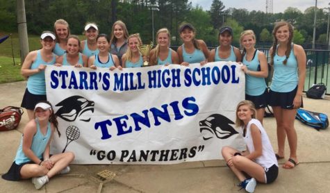 The Starr’s Mill girls tennis team takes a picture with their first place trophy after regions. The Lady Panthers won regions 3-0 allowing them to progress to state. 