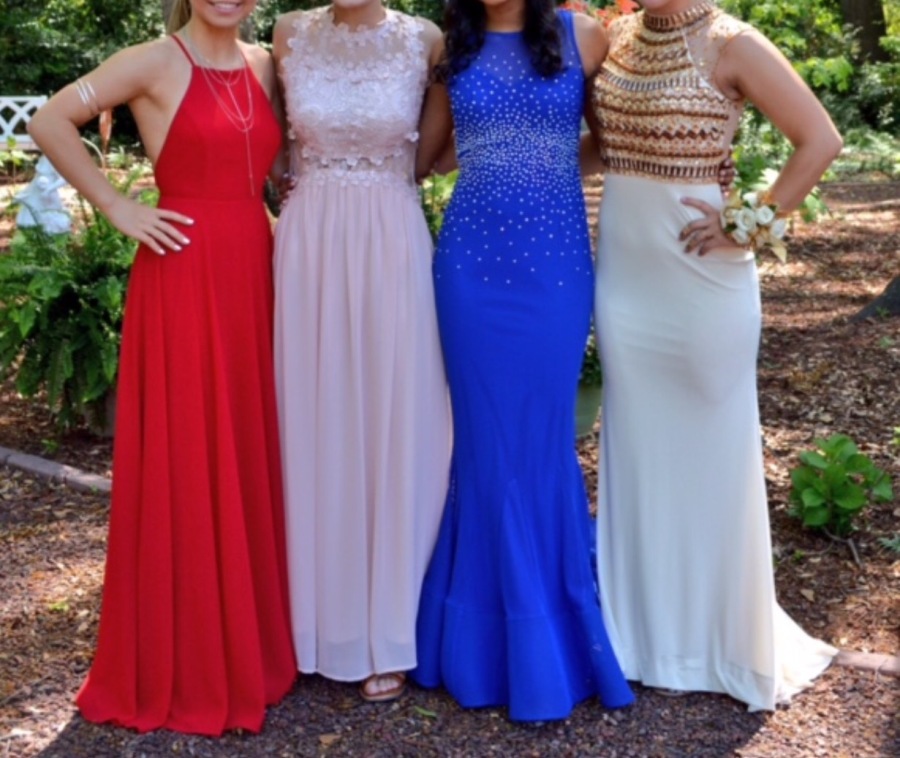 A+group+of+girls+show+off+their+prom+dresses+for+Whitewater+High+Schools+dance.+Two+of+the+four+dresses+are+accented+with+design+and+jewels.+