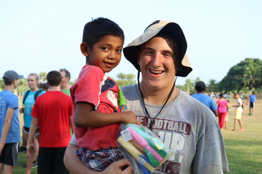 A Starr’s Mill student snaps a picture with a child from a village before leaving. The mission team brought suitcases full of toys including play doh, jump ropes, nail polish, soccer balls, and bubbles for each village. Each child was able to take home a few of the toys and each night we went back to the house with empty suitcases and full hearts. 