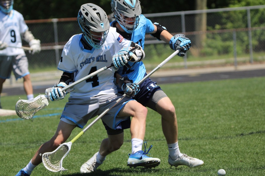 Sophomore Reid Harrison and a Lovett defender fight for a loose ball. While the Panthers did well on the faceoffs, the Lions out-hustled the Panthers on almost every loose ball.