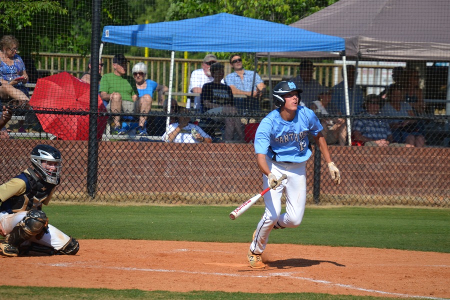 Senior Jake Arnold watches the ball as he runs to first. Arnold hit a double, triple, and a sacrifice RBI to help his cause in game one as he got the win, 9-1 against Decatur.