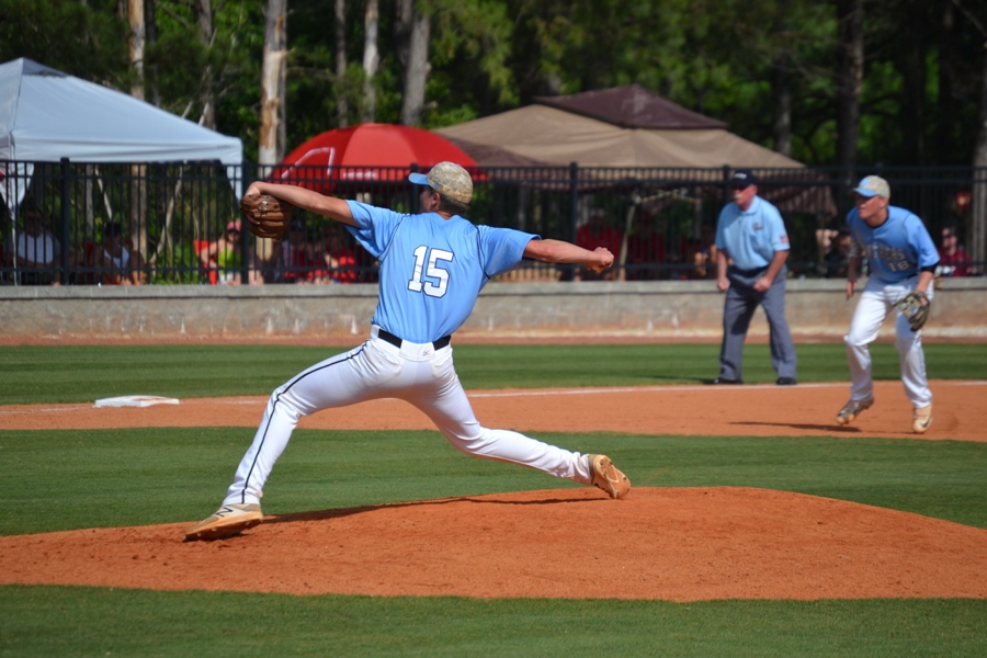 Senior Jake Arnold throws a curveball to a Red Devil batter. Arnold pitched a complete game shutout in game one against the Red Devils, striking out five batters in seven innings. 