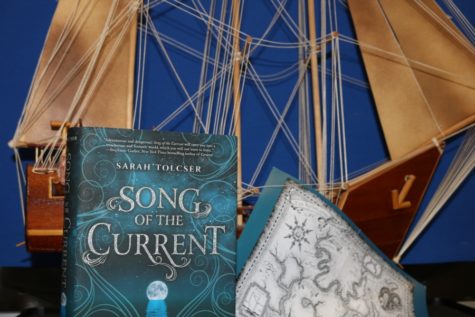 “Song of the Current” is an exhilarating fantasy novel that follows Caroline Oresteia on her journey through the Riverlands to discover her destiny and save her father. This book is a part of Uppercase box, a program that sends members a new, hardcover young adult novel each month.  