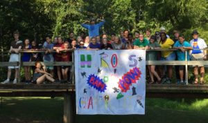 Underclassmen pose for a picture with their banner. Their banner was hero themed while the seniors’ banner was villain themed.