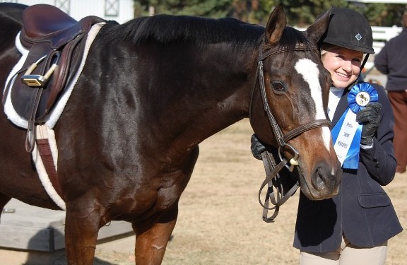 Junior Caitlyn Gloriod celebrates a win with her horse Bailey. She and several other girls at Starr's Mill spend a considerable amount of time riding horses. A win like this makes it all worth it.