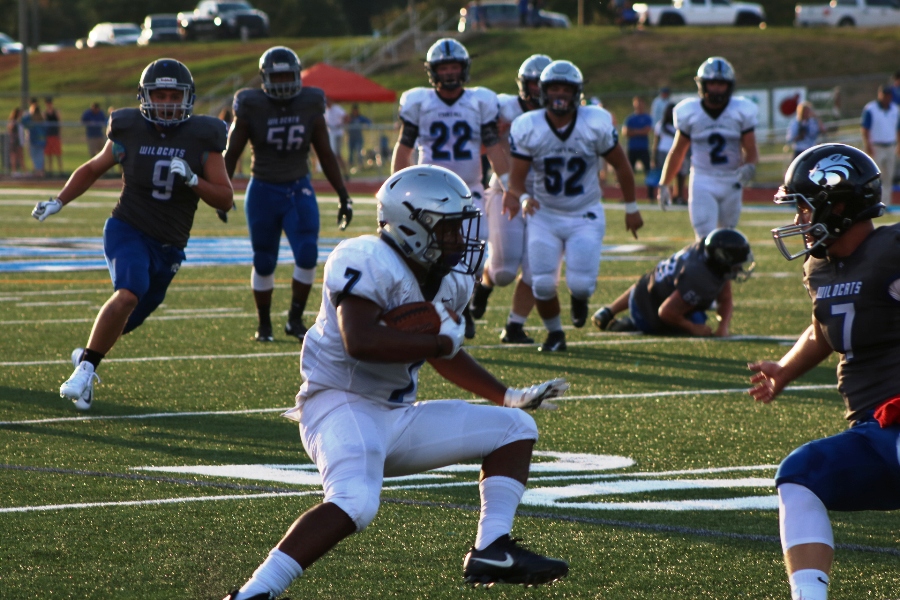 Senior+Nick+Brown+jukes+past+a+Wildcat+defender+on+his+way+to+the+end+zone.+Brown+rushed+for+two+touchdowns+during+the+scrimmage+at+Locust+Grove.