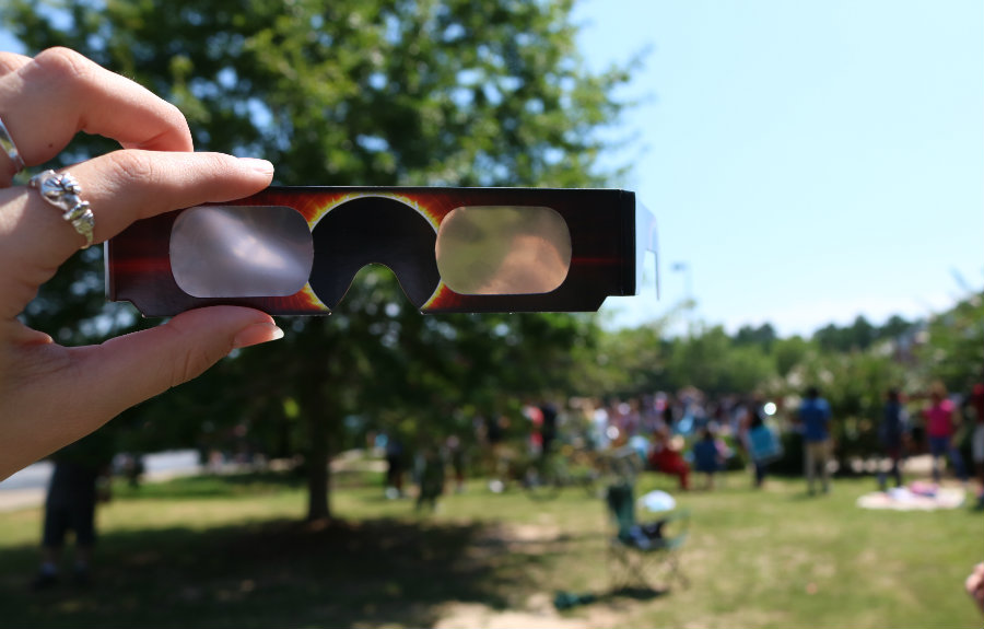 Aug. 21, 2017 - Students gather outside of the attendance office to watch the solar eclipse. This was the first eclipse to cross from one side of the United States to the other in 99 years. The next one with be in 2024. 