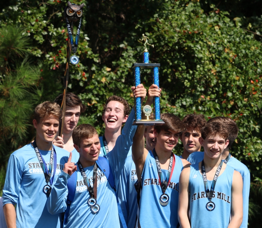 The varsity boys’ cross country team holds up their 1st place trophy after a successful meet on Sept. 2 at Heritage Church. The Panthers ended the meet with the top runners finishing 1-2.