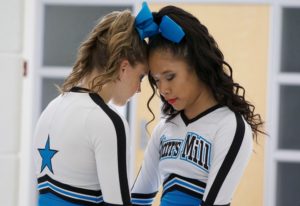 Two Starr’s Mill cheerleaders take a moment of silence to collect themselves before competing. Last Saturday, the cheer team competed in its first regional competition under new head coach Heather McNally.