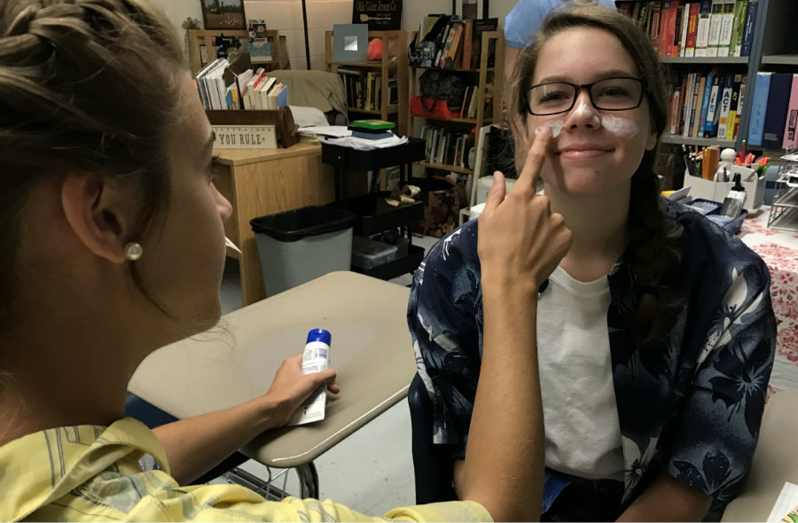 Sept. 1, 2017 - Junior Emily Egan applies sunscreen to another juniors face on “Tacky Tourist” day. “Tacky Tourist” day is one of five dress up days for homecoming week. Other dress up days for the juniors include 70s day, PTC mom’s and dad’s day, character day, and spirit day. 