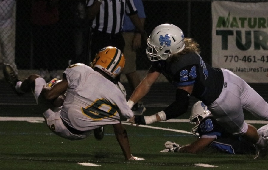 Senior defensive end Coltin Houser swings down a Griffin player. Houser constantly disrupted the Bears’ offense before leaving the game with an injury.