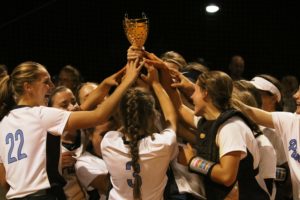 The Lady Panthers softball team hoists their region championship trophy. After sweeping the region tournament, Starr’s Mill won their first region title in 11 years.