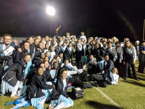 Panther Pride marching band poses with their Grand Champion trophy from the Golden Riven Marching Festival. They performed their 2017 show “Swan Lake Reimagined.”