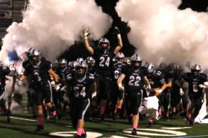 The Panthers run through the team banner before their game against Fayette County. After their 44-13 victory over the Tigers, Starr’s Mill won their second consecutive region championship.