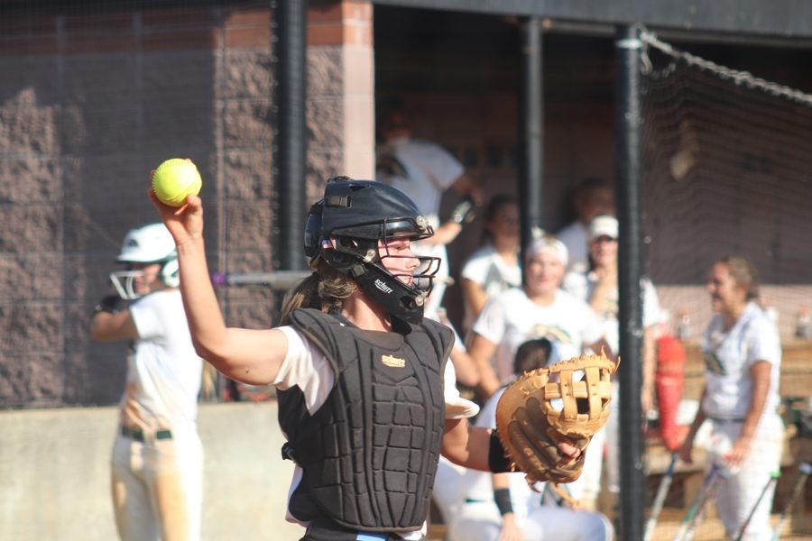 Junior Kate Ashmore throws the ball after catching it from a pitcher. She was one of the team leaders in runs batted in.