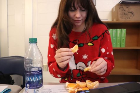 Starr’s Mill student enjoys an orange as a healthy snack alternative to chips or cookies. Eating fruits and vegetables, as well as drinking plenty of water, may help subdue an individual’s appetite between holiday meals. 