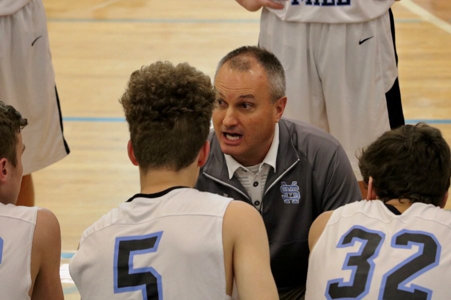 Coach Evert instructs his junior varsity basketball team mid-game. Evert is a former hall of fame player for his high school and his college team.