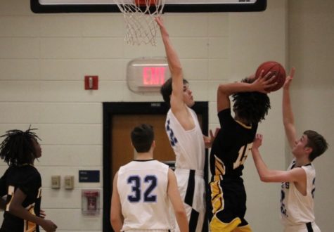 Sophomore forward Barrett Hester attempts to block a shot. Good defense allowed the Panthers to narrowly defeat Fayette County 47-45.