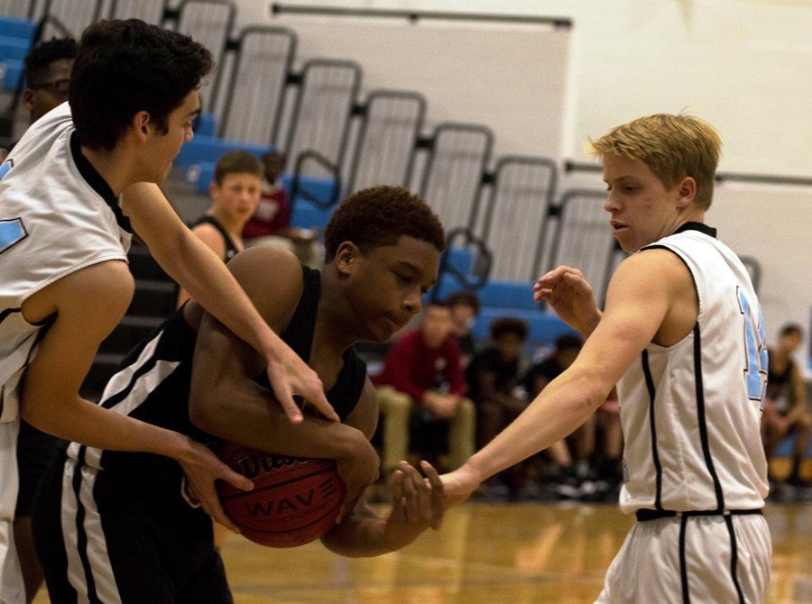 Two freshmen players attempt to steal the ball from a Whitewater player. The Panthers played good defense until the fourth quarter, where they fell apart and eventually lost the game.