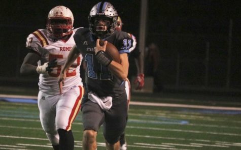 Senior quarterback Joey DeLuca races away from a Rome defender. DeLuca was the starting quarterback for the Mill for three years, winning at least one playoff game each of those seasons.