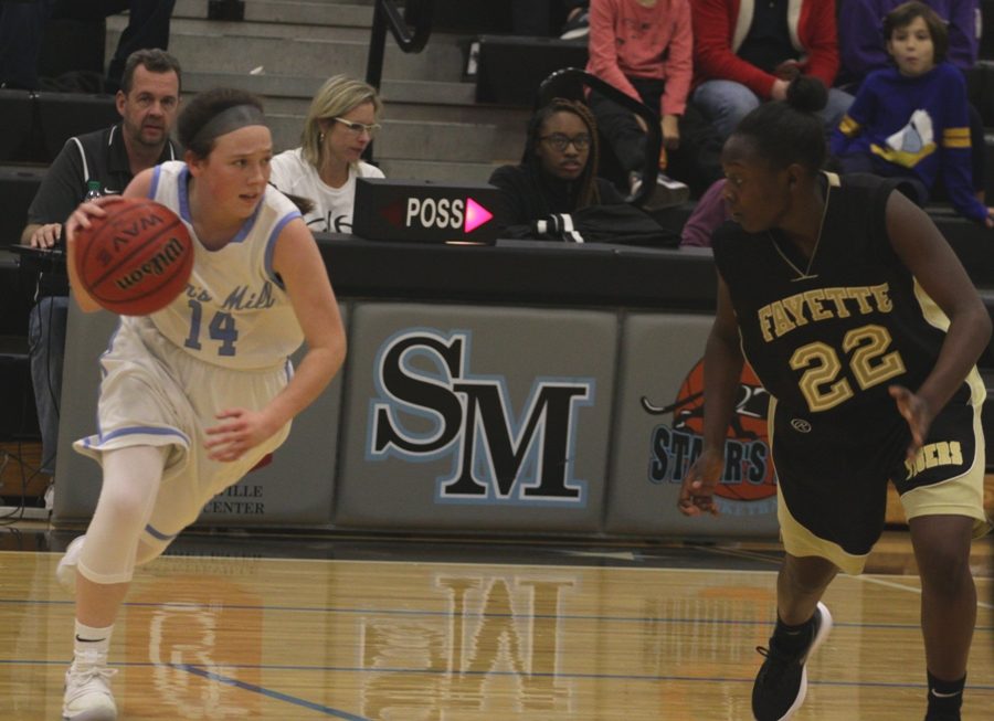 A sophomore player dribbles the ball up the court. The Lady Panthers had to advance the ball through a half court press for most of the game.