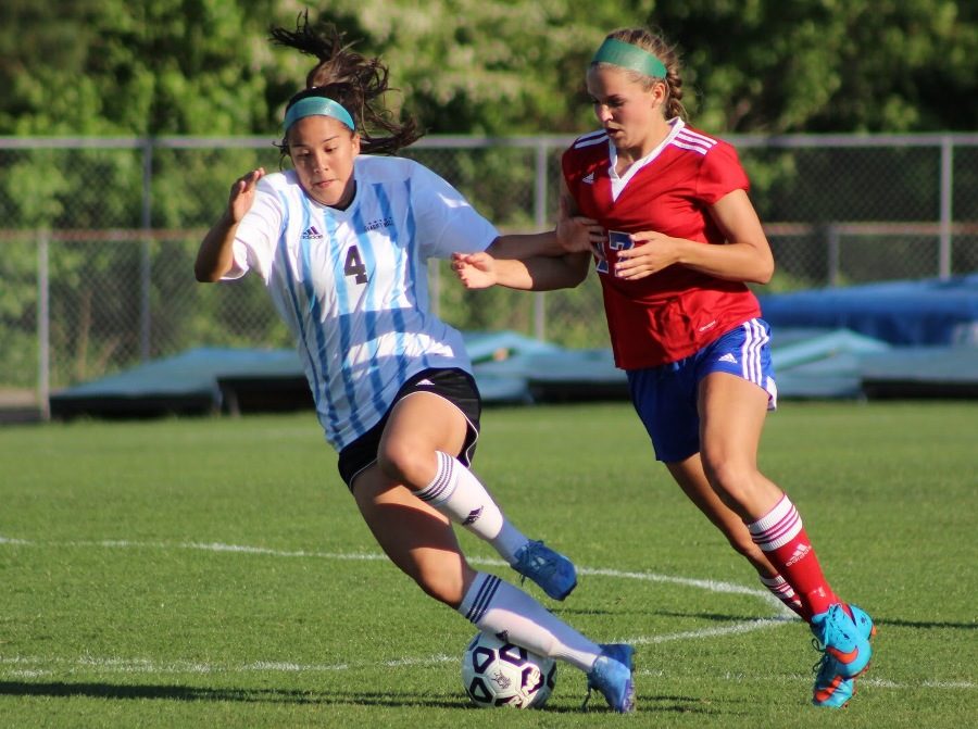 Alum Dylan Patterson drives the ball while a defender attacks aggressively. Patterson, in her sophomore year of college, has joined the Philippines national team to play in the 2019 FIFA Women’s World Cup in France.