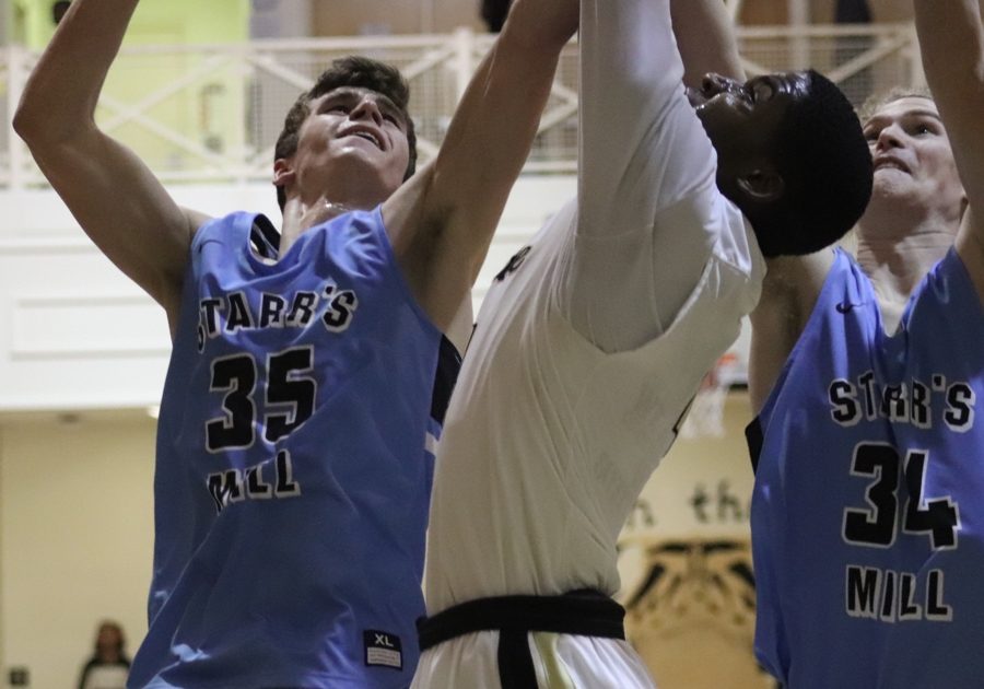 Two Starr’s Mill forwards battle a Fayette player for a rebound. The Panthers played physically on both ends of the court, crashing the glass on almost every missed shot.