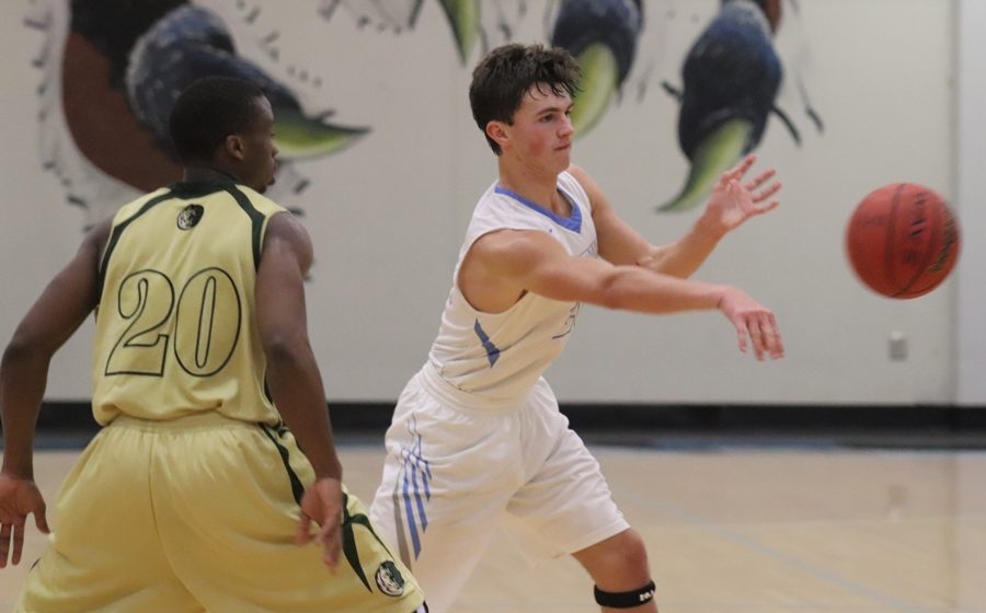 A Panther guard passes the ball to a teammate. The Panthers moved the ball well against Morrow, totaling 14 assists.