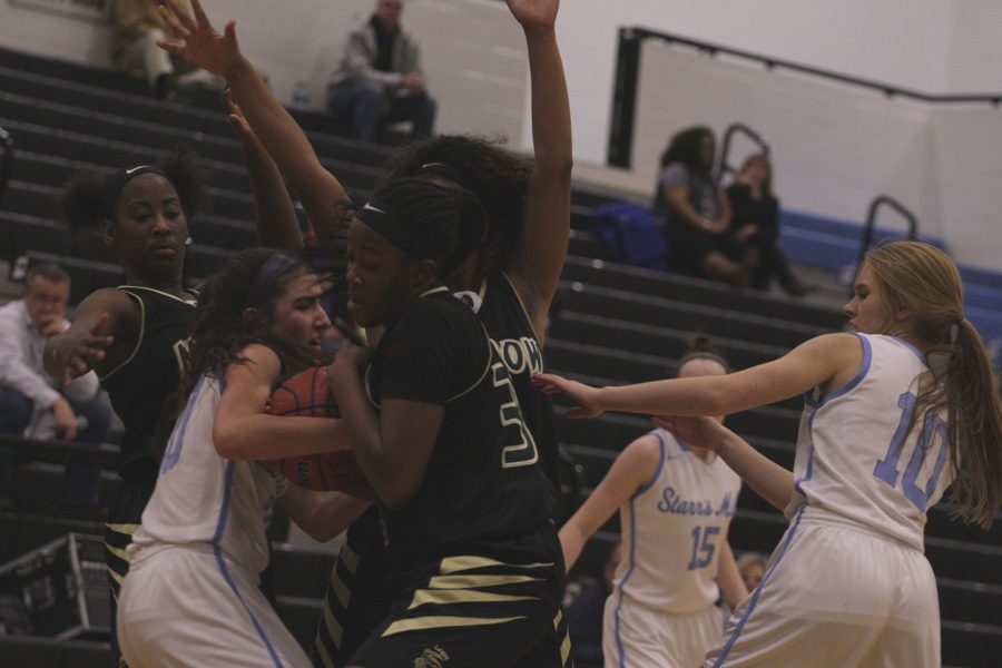 Mustang defenders swarm a Lady Panther after a rebound. Morrow’s size caused problems for the Mill as they ended the game with 12 more rebounds than the home team.

