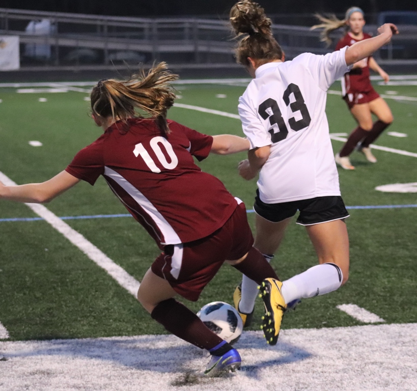 Freshman Chloe Thompson battles a Viking player for the ball. In a home game on Feb. 9, the Mill tied Northgate 2-2.
