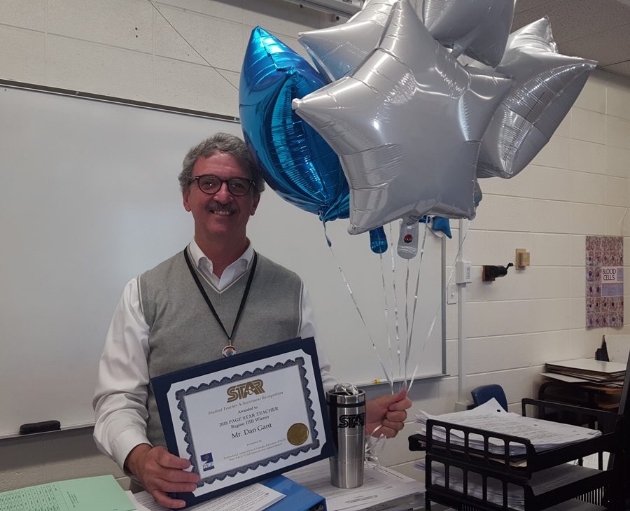 Science teacher Dan Gant surrounded by prizes given to him after Star Student Bryce Smith selected him as Star Teacher. Gant will support and write a letter of recommendation for Smith. Smith and Devin Lohman tied for Star Student at the local and regional level. Both will now travel to the state competition on April 23. 