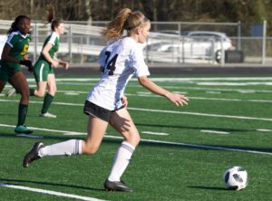 Senior Kirsten Oates dribbles the ball down the field outside of the goalie box. The Mill dominated the Griffin Bears in a shutout region match 10-0.