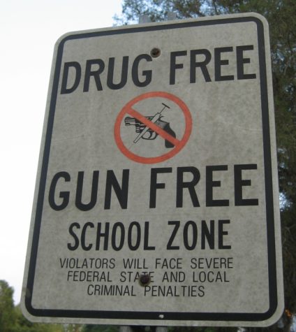 A sign prohibiting drugs and guns stands outside of a school. If teachers were to be armed, schools shootings may be a thing of the past. 