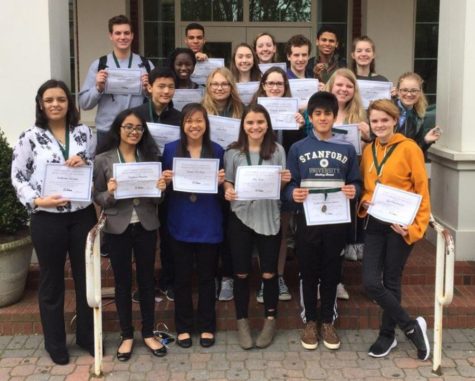Students pose with their awards from the Foreign Language Association of Georgia Spoken Language Contest. The group of 21 students returned to the Mill with 14 superior rankings, five excellent, and two distinguished. 