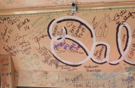 Signatures of race fans decorate the inside of the Oreo bus.  The Oreo bus is a school bus that was converted into a “racing bus,” a bus designed to watch NASCAR races live in the infield. Theres thousands and thousands of names, long-time NASCAR fan Ian Earnest said.